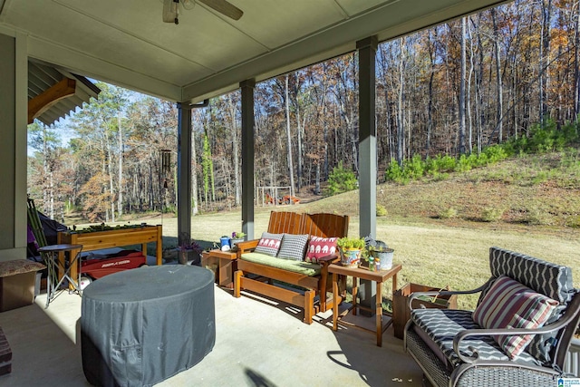 sunroom / solarium featuring ceiling fan