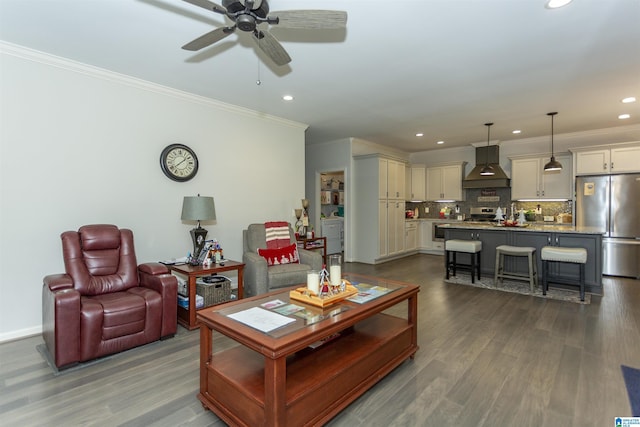 living room featuring hardwood / wood-style flooring, ceiling fan, and crown molding