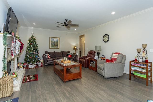 living room featuring hardwood / wood-style flooring, ceiling fan, and crown molding