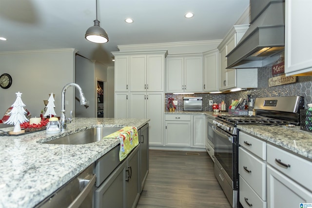 kitchen featuring light stone countertops, sink, stainless steel appliances, premium range hood, and white cabinets