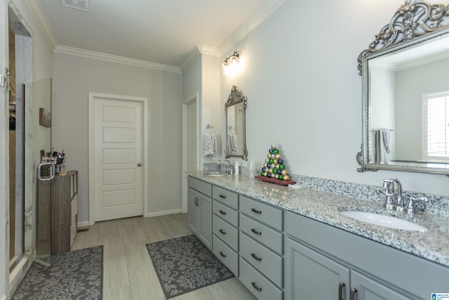 bathroom featuring vanity, a shower with door, and crown molding