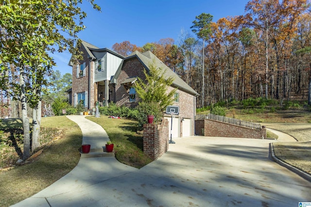 view of property exterior featuring a garage and a lawn