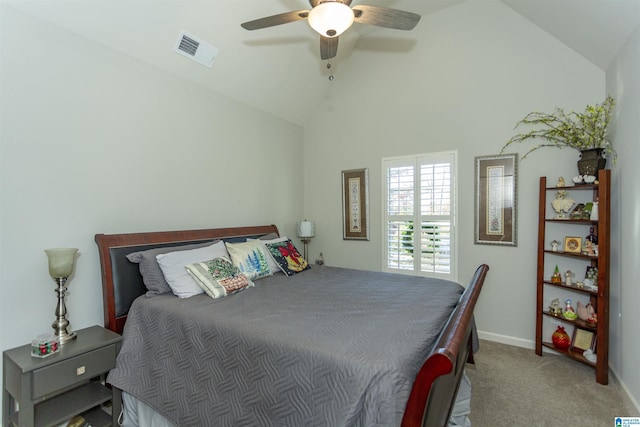 carpeted bedroom with ceiling fan and vaulted ceiling