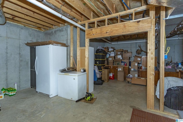 basement with white refrigerator