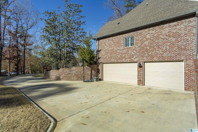 view of home's exterior featuring central AC and a garage