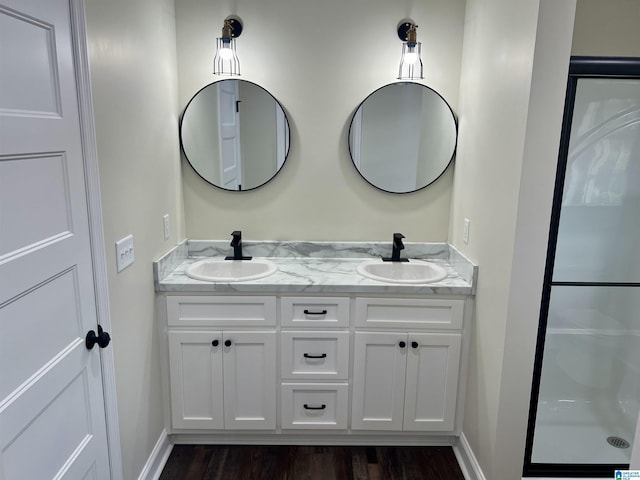 bathroom with vanity, wood-type flooring, and walk in shower