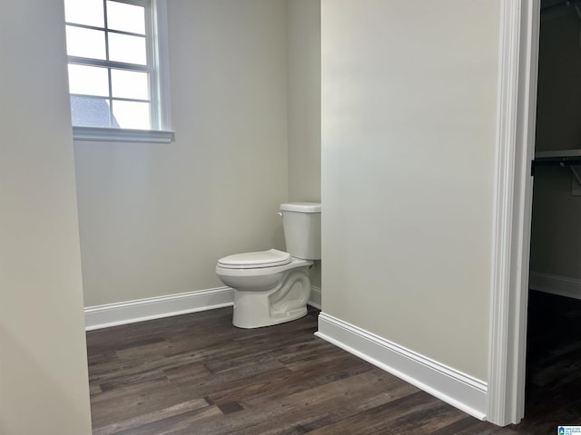 bathroom with hardwood / wood-style floors and toilet