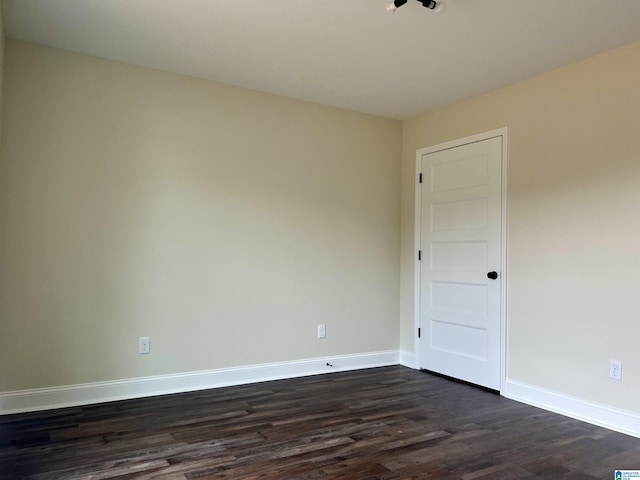 unfurnished room with dark hardwood / wood-style floors