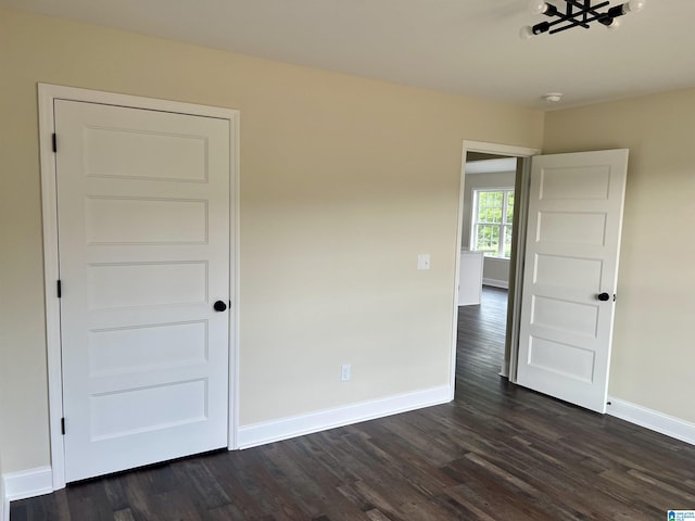 unfurnished room featuring dark hardwood / wood-style flooring