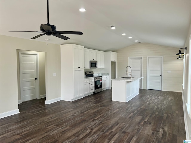 kitchen with white cabinetry, sink, an island with sink, lofted ceiling, and appliances with stainless steel finishes