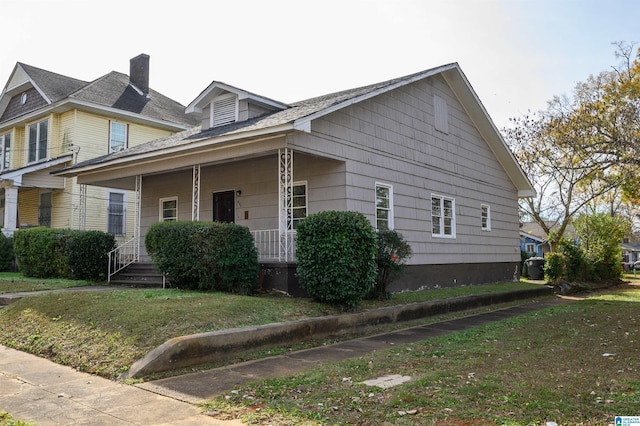 view of home's exterior with a porch and a yard