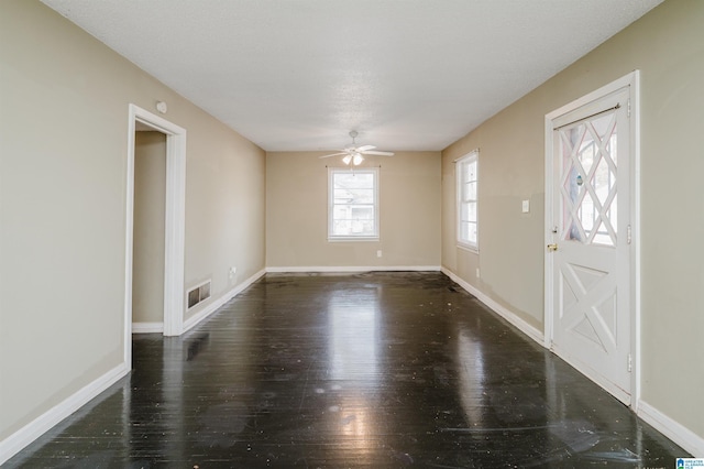 entryway with dark hardwood / wood-style floors and ceiling fan