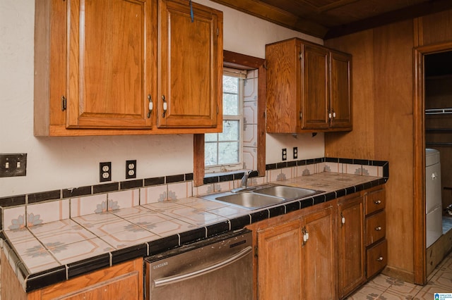 kitchen with stainless steel dishwasher, sink, and tile countertops