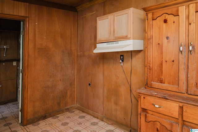 laundry area featuring wooden walls