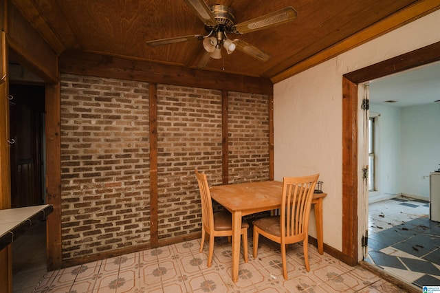 dining room featuring ceiling fan, wood ceiling, and brick wall