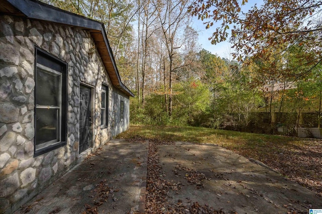 view of side of home with a patio area