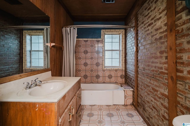 full bathroom with vanity, toilet, shower / bath combo with shower curtain, and brick wall