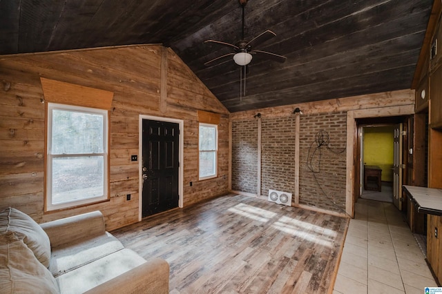 unfurnished living room featuring ceiling fan, wooden ceiling, brick wall, vaulted ceiling, and wooden walls