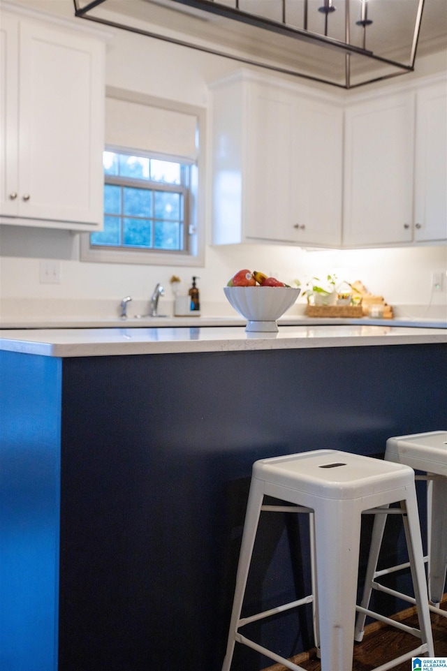 kitchen with white cabinetry and sink