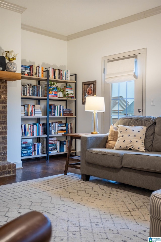 sitting room featuring a fireplace, ornamental molding, and hardwood / wood-style flooring