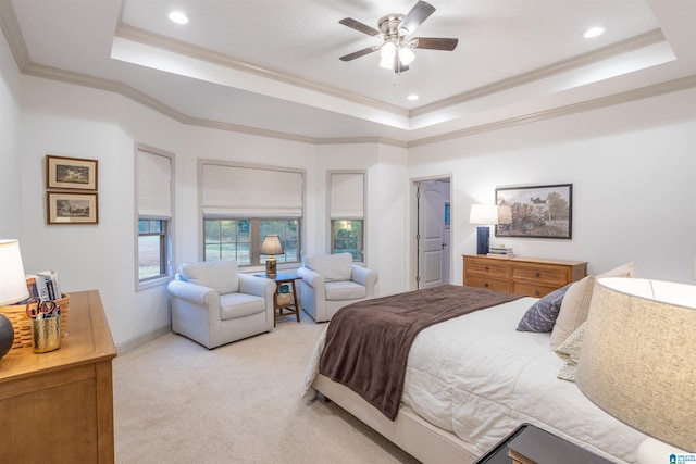 carpeted bedroom featuring a raised ceiling, ceiling fan, and ornamental molding