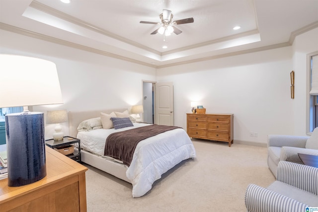 carpeted bedroom featuring a raised ceiling, ceiling fan, and ornamental molding