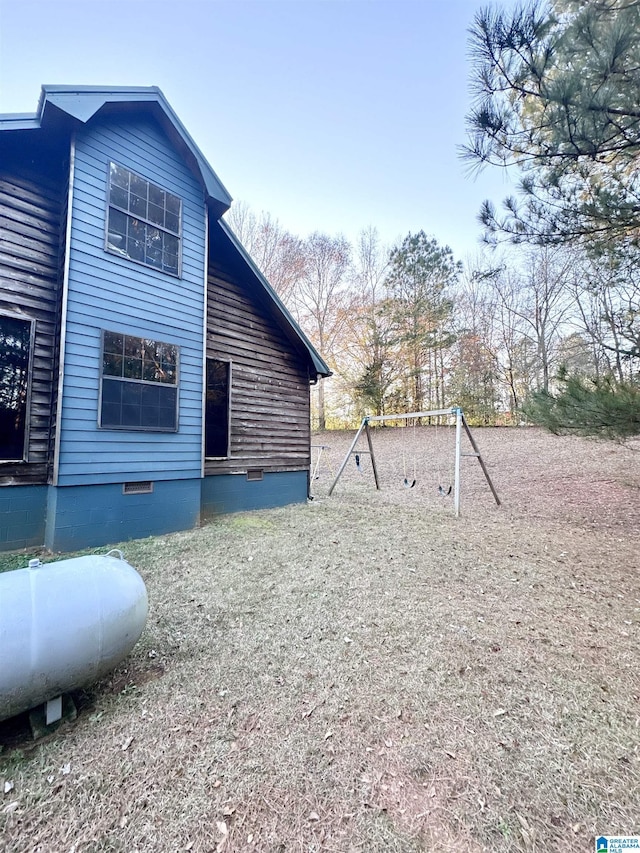 view of side of home featuring a playground