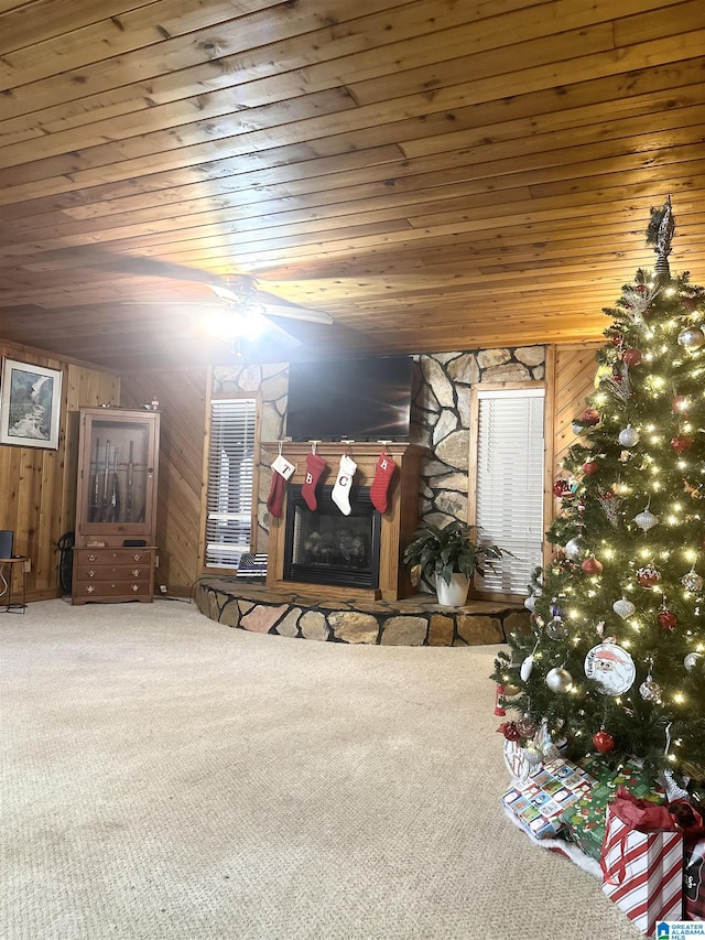 unfurnished bedroom featuring wooden walls, a fireplace, and wood ceiling