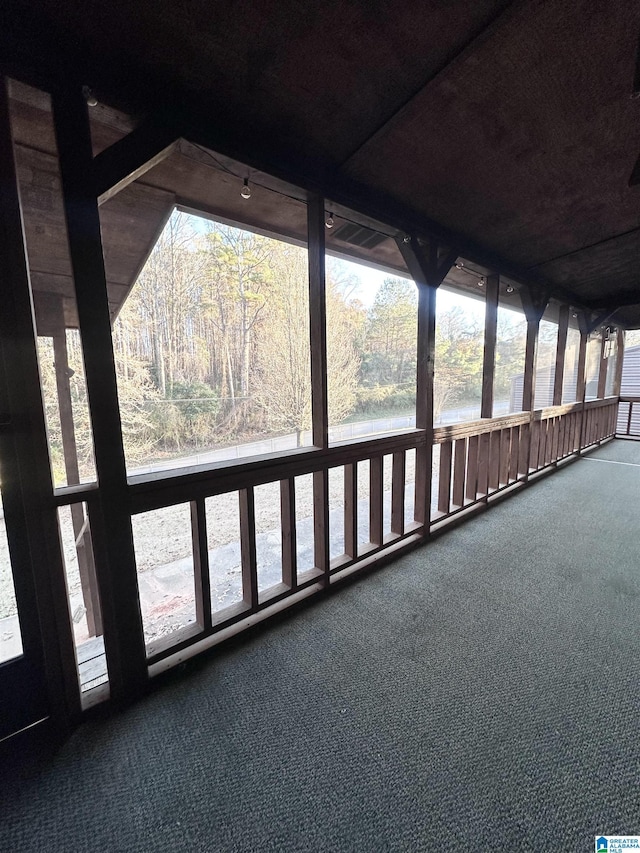 unfurnished sunroom featuring a water view