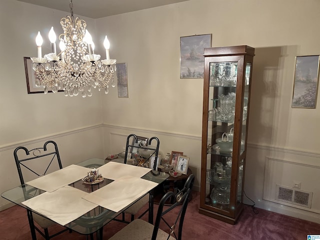 carpeted dining room with a notable chandelier