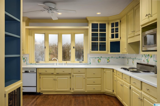 kitchen featuring white appliances, ceiling fan, crown molding, sink, and dark hardwood / wood-style floors