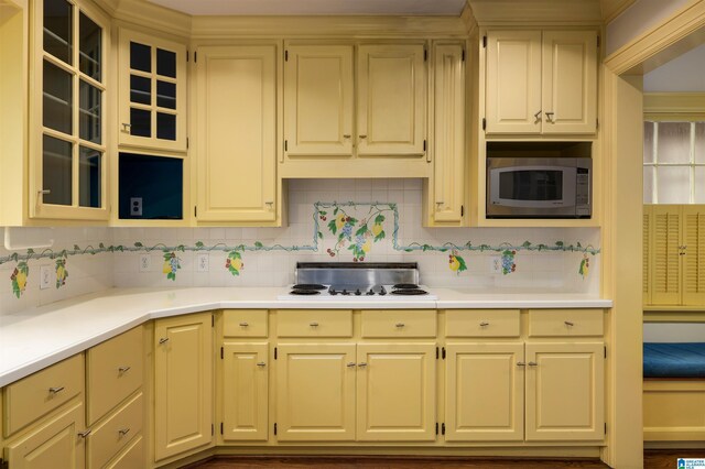 kitchen featuring hardwood / wood-style floors, stainless steel appliances, and tasteful backsplash