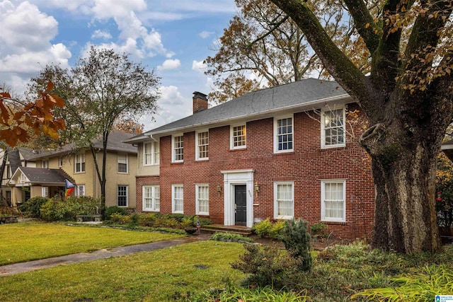 colonial inspired home with a front yard