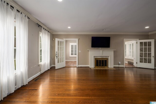 unfurnished living room with baseboard heating, french doors, dark wood-type flooring, and ornamental molding