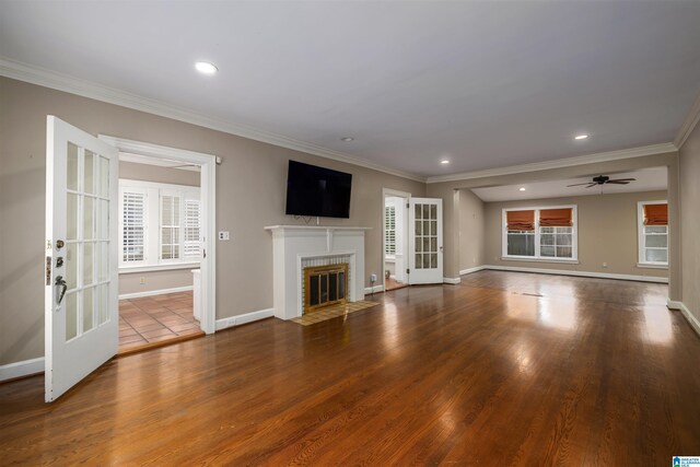 unfurnished living room with a fireplace, hardwood / wood-style flooring, and a healthy amount of sunlight