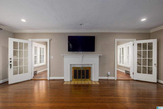 unfurnished living room with crown molding, dark wood-type flooring, and french doors