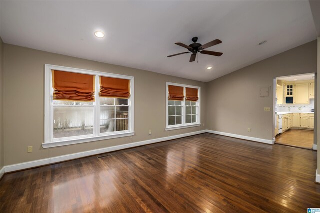 unfurnished living room featuring dark hardwood / wood-style floors, a healthy amount of sunlight, and lofted ceiling