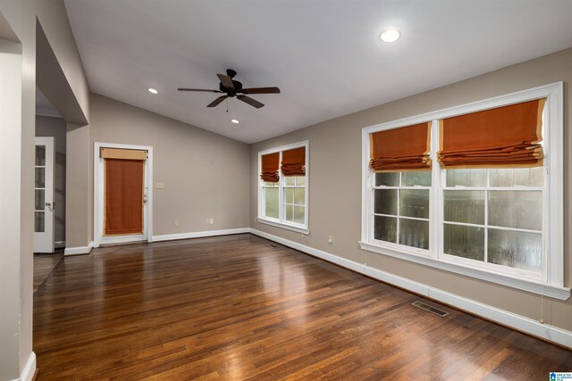 unfurnished living room featuring ceiling fan, lofted ceiling, and dark wood-type flooring