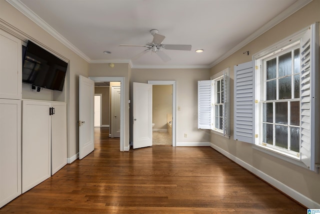 unfurnished bedroom featuring ceiling fan, dark hardwood / wood-style floors, crown molding, and ensuite bath