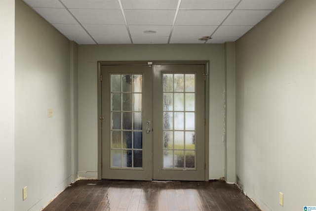 entryway with french doors, dark hardwood / wood-style floors, and a drop ceiling