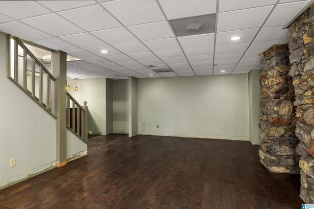 basement featuring a drop ceiling and wood-type flooring