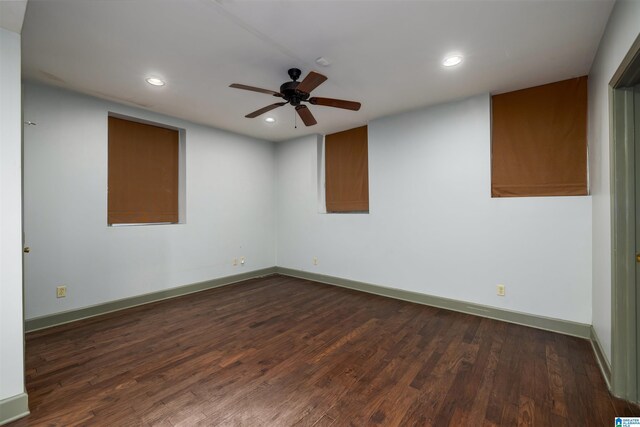 spare room with ceiling fan and dark wood-type flooring