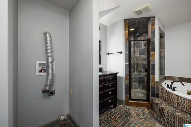 bathroom featuring tile patterned floors, vanity, and shower with separate bathtub