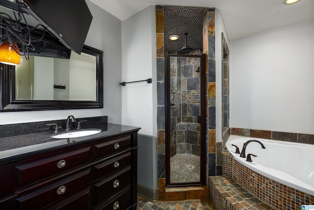 bathroom with vanity and independent shower and bath