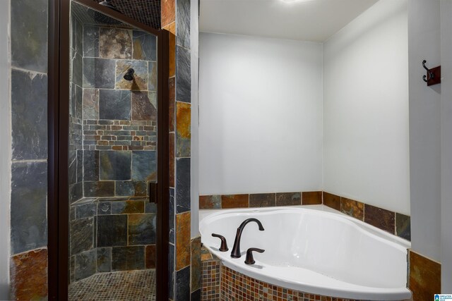 bathroom featuring tiled bath