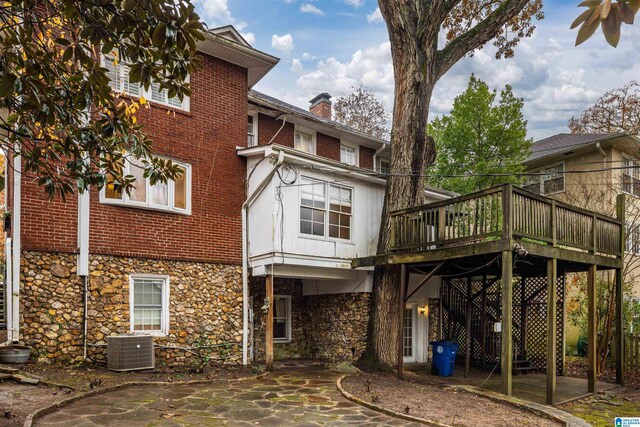 back of property with a patio area, central AC unit, and a deck