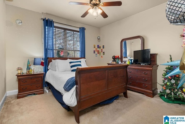 bedroom with ceiling fan and light carpet