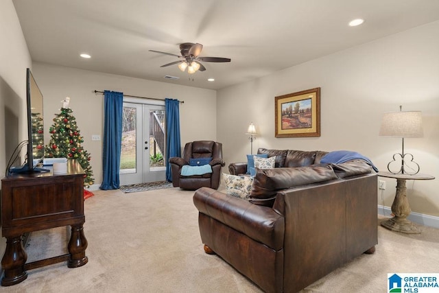 living room featuring french doors, light colored carpet, and ceiling fan