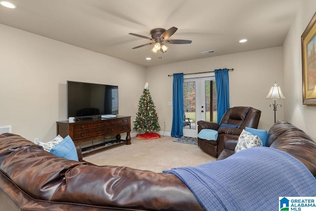 living room featuring french doors, light colored carpet, and ceiling fan