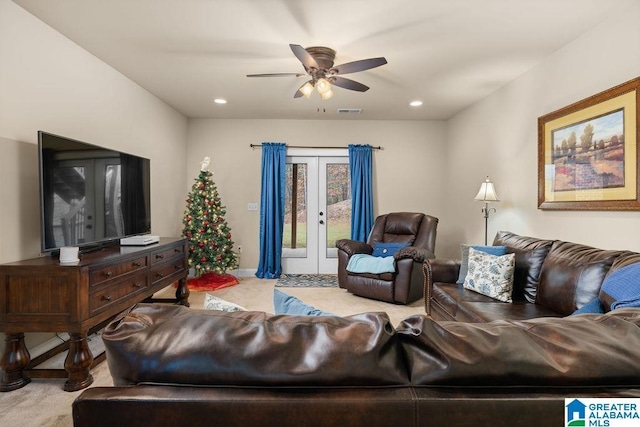 living room with ceiling fan, light carpet, and french doors